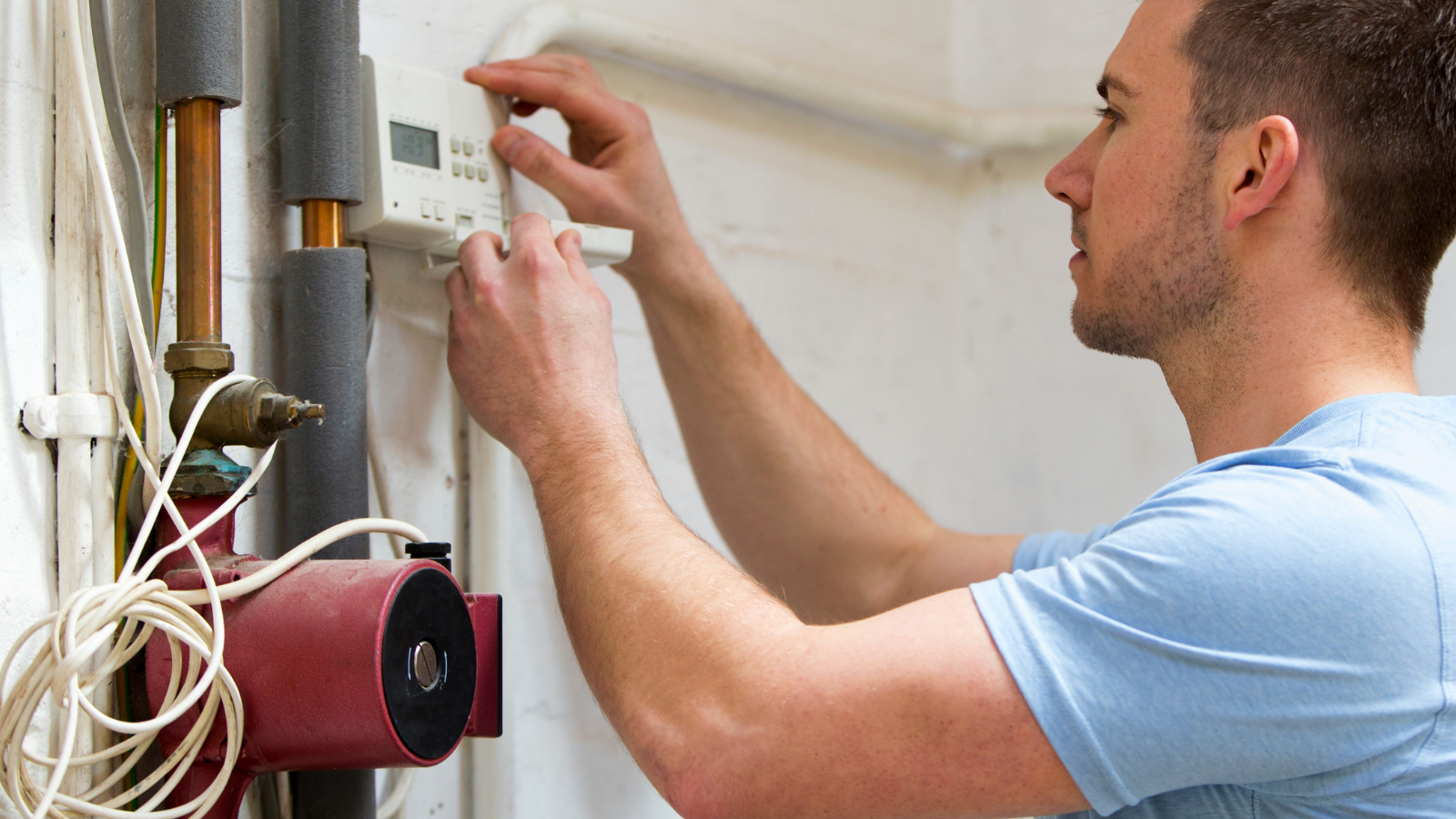 man performing heating repairs
